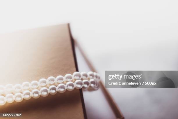pearl jewellery in a golden gift box - editorial stock pictures, royalty-free photos & images