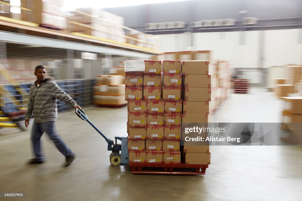 Worker moving boxes in a warehouse