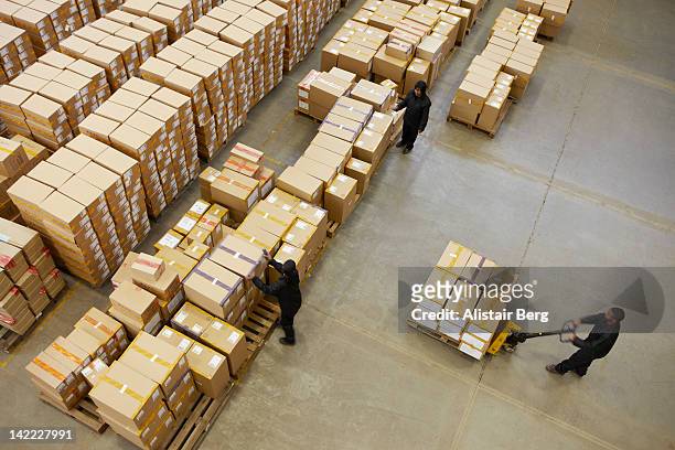 elevated view of workers in a warehouse - storage room boxes stock pictures, royalty-free photos & images