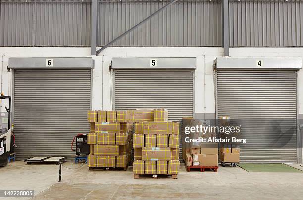 boxes stacked up inside a warehouse - loading docks stock pictures, royalty-free photos & images