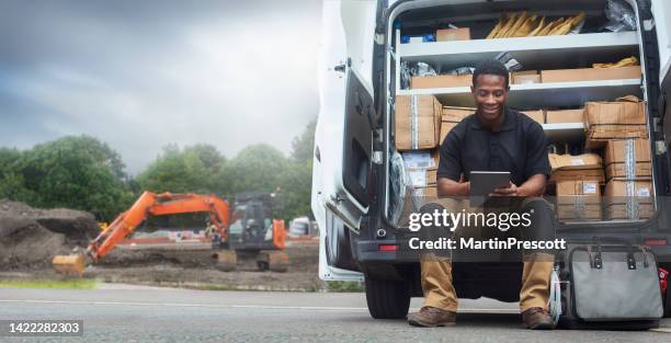 service engineer sat on the back step of his van - veículo terrestre comercial imagens e fotografias de stock