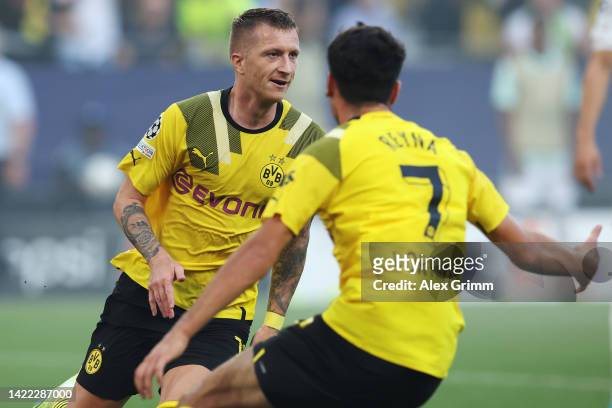 Marco Reus of Borussia Dortmund celebrates their team's first goal with teammate Giovanni Reyna during the UEFA Champions League group G match...