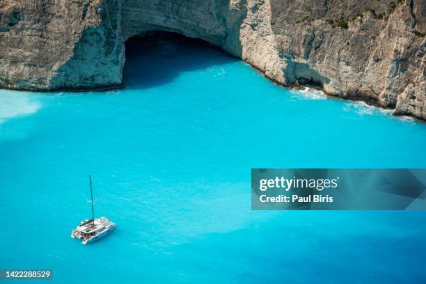 aerial view of a yacht near the navagio (shipwreck) beach in zakynthos island, greece - yacht top view stock pictures, royalty-free photos & images