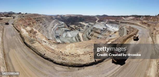mining dumptruck and water tank in an open pit copper mine - mina de superficie fotografías e imágenes de stock