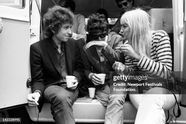 Musicians Bob Dylan, Donovan, and Mary Travers of Peter Paul and Mary backstage at the Newport Folk Festival in July 1965 in Newport, Rhode Island.