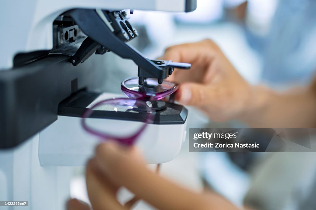Unrecognizable person measuring glass on eyewear