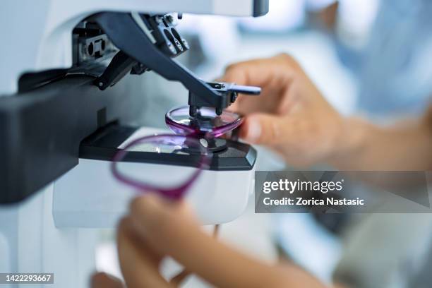 unrecognizable person measuring glass on eyewear - eyesight stock pictures, royalty-free photos & images