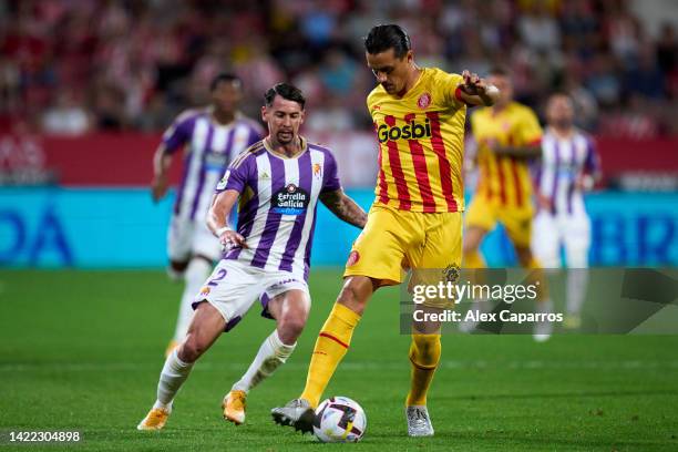 Bernardo Espinosa of Girona FC is challenged by Luis Perez of Real Valladolid CF during the LaLiga Santander match between Girona FC and Real...