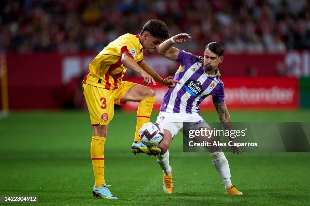 Miguel Gutierrez of Girona FC is challenged by Luis Perez of Real Valladolid CF during the LaLiga Santander match between Girona FC and Real...