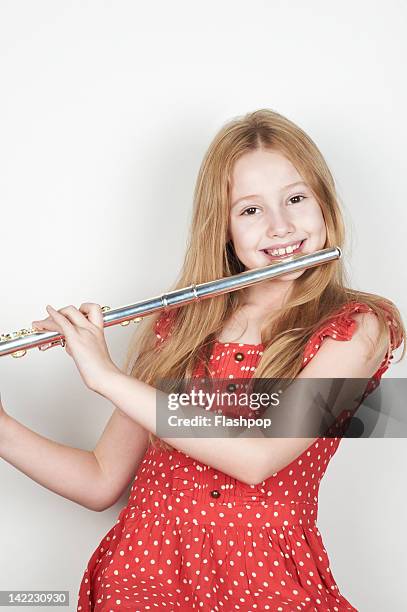 portrait of girl playing musical instrument - flauto foto e immagini stock