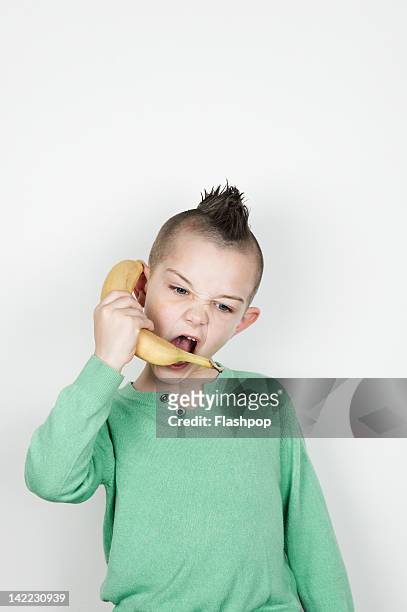 portrait of boy holding a banana - banana phone stock pictures, royalty-free photos & images