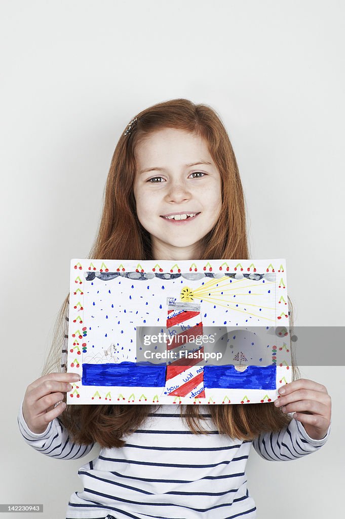 Portrait of girl holding her painting