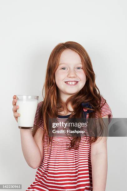 portrait of girl drinking a glass of milk - portrait indoors stock pictures, royalty-free photos & images