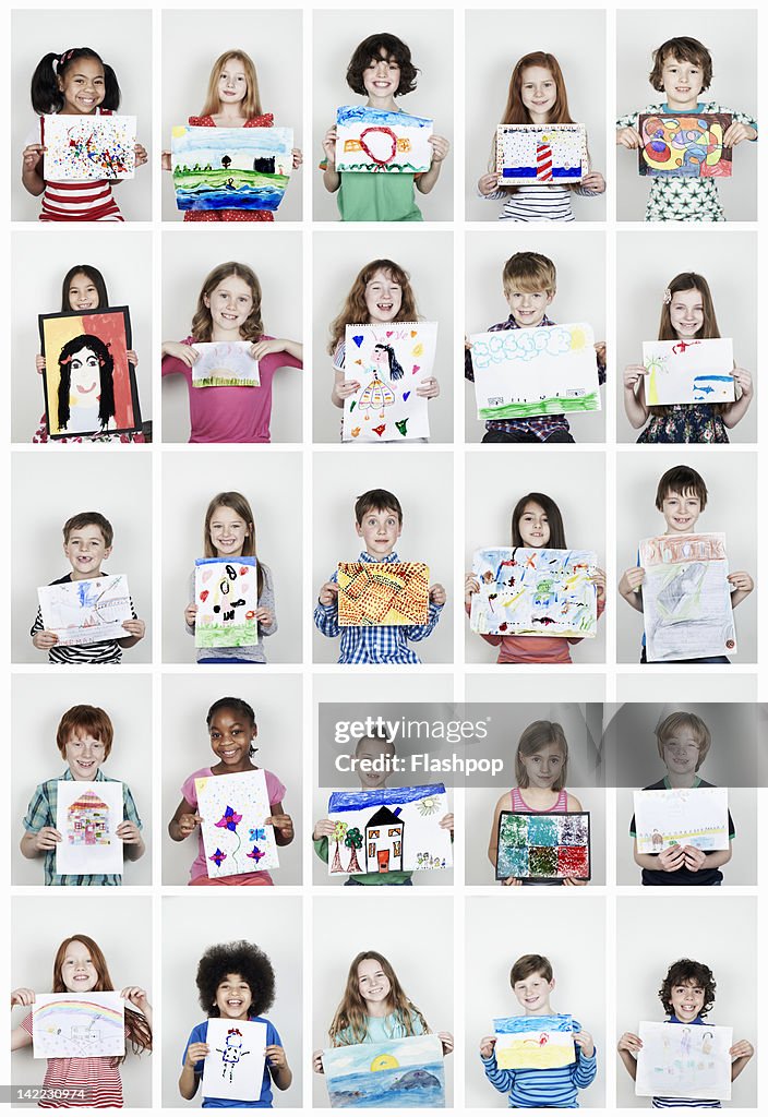 Portrait of children holding their art work