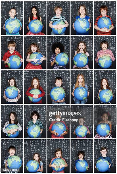 group of children holding a globe in class - happy people holding a white board stock pictures, royalty-free photos & images