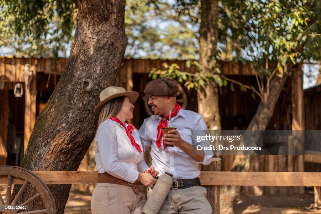 Gaucho couple drinking chimarrao at the farroupilha camp