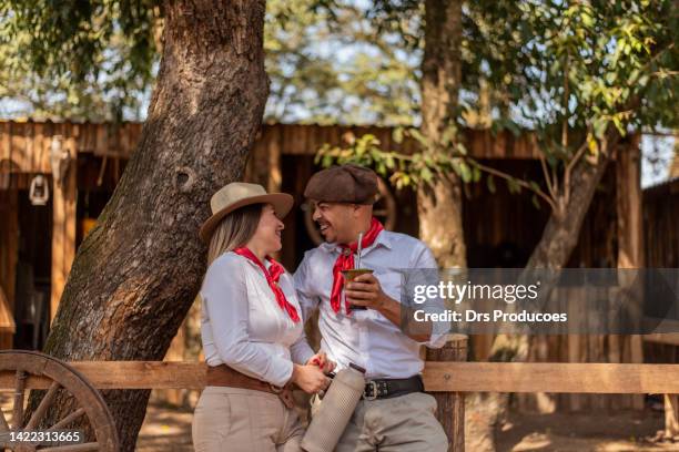 gaucho couple drinking chimarrao at the farroupilha camp - gaucho stock pictures, royalty-free photos & images
