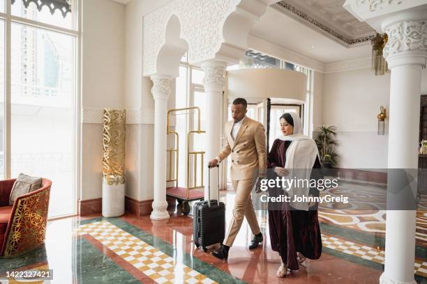 couple vacationing in riyadh arriving at hotel - arabia travel stock pictures, royalty-free photos & images