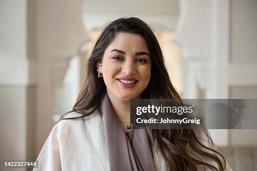 Indoor portrait of cheerful Middle Eastern businesswoman Indoor portrait of cheerful Middle Eastern businesswoman