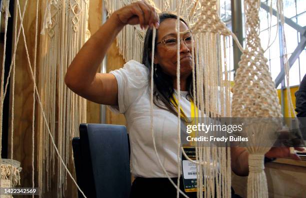 An artisan weaves macramé as part of Expoartesano XIII at Plaza Mayor on September 09, 2022 in Medellin, Colombia. Expoartesano is an encounter with...