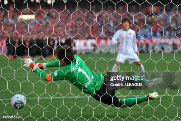 Seigo Narazaki of Nagoya Grampus saves the penalty taken by Toru Araiba of Kashima Antlers to win the match during the penalty shootout following the...