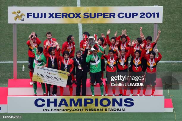 Captain Seigo Narazaki of Nagoya Grampus lifts the trophy at the award ceremony following the Fuji Xerox Super Cup between Nagoya Grampus and Kashima...