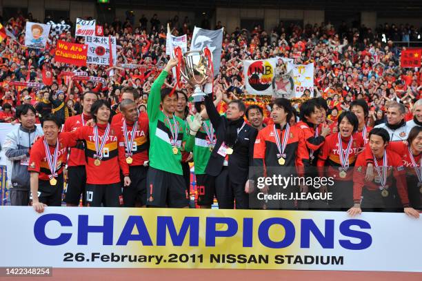 Nagoya Grampus players and staffs celebrate following the Fuji Xerox Super Cup between Nagoya Grampus and Kashima Antlers at Nissan Stadium on...