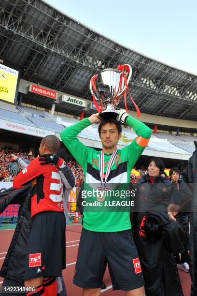 Captain Seigo Narazaki of Nagoya Grampus presents the trophy for supporters following the Fuji Xerox Super Cup between Nagoya Grampus and Kashima...