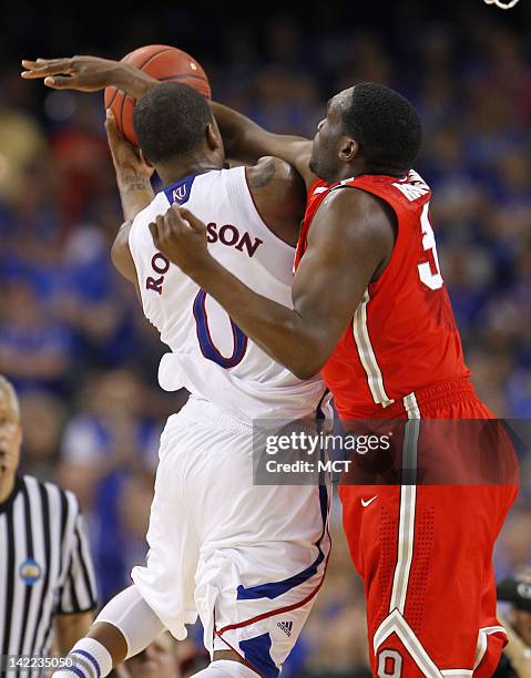 Evan Ravenel, right, of Ohio State defends Thomas Robinson of Kansas in the NCAA Tournament semifinals at the Mercedes-Benz Superdome in New Orleans,...