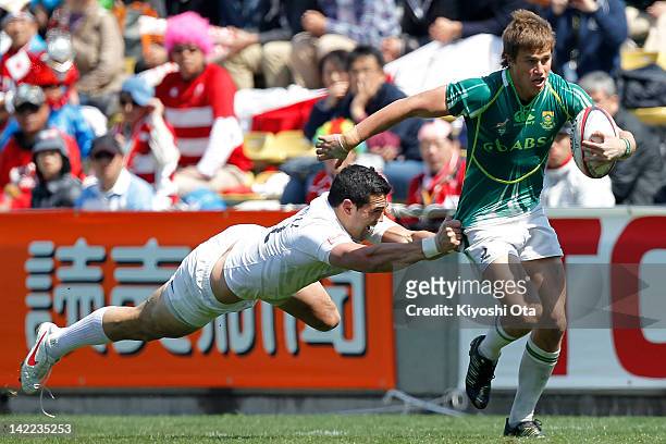 William Small-Smith of South Africa runs past Chris Brightwell of England in the Cup Quarter Final match between England and South Africa during day...