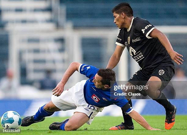 Christian Gimenez of Cruz Azul and Moises Velasco of San Luis struggle for the ball during a match between Cruz Azul v San Luis as part of Torneo...