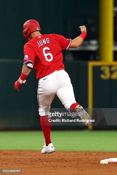 Josh Jung of the Texas Rangers raises his fist as he runs the bases after a solo home run in the third inning against the Toronto Blue Jays in his...