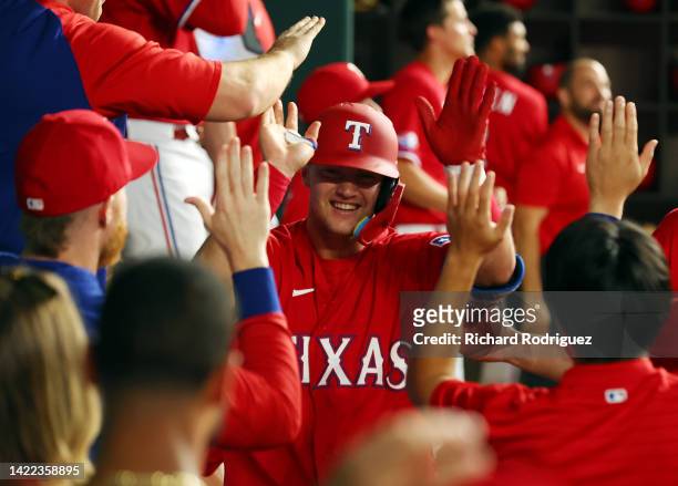 Josh Jung of the Texas Rangers is greeted in the dugout after a solo home run against the Toronto Blue Jays in the third inning at Globe Life Field...
