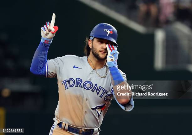 Bo Bichette of the Toronto Blue Jays gestures as he runs the bases after a two-run home run against the Texas Rangers in the third inning at Globe...