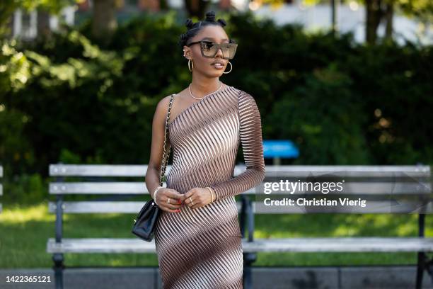 Guest is seen wearing brown dress, black bag outside Bronx & Banco on September 09, 2022 in New York City.