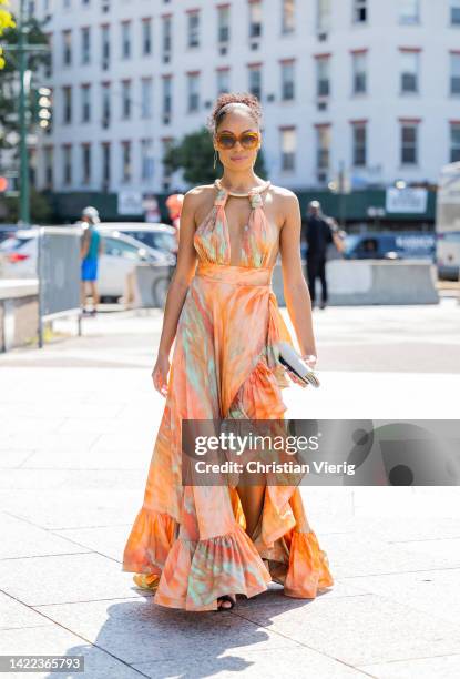 Guest is seen wearing orange dress outside Bronx & Banco on September 09, 2022 in New York City.