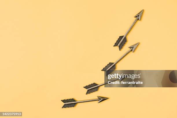 arrows pointing up - bow and arrow stock pictures, royalty-free photos & images