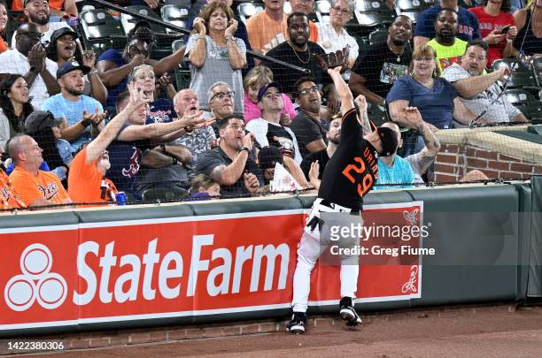 Ramon Urias of the Baltimore Orioles catches a foul ball hit by Rafael Devers of the Boston Red Sox in the fifth inning at Oriole Park at Camden...