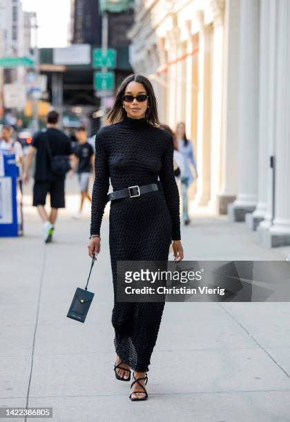 Guest wearing black belted dress outside Proenza Schouler on September 09, 2022 in New York City.