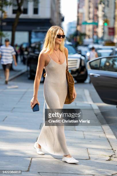 Jessie Andrews wearing oversized bag, beige dress outside Proenza Schouler on September 09, 2022 in New York City.