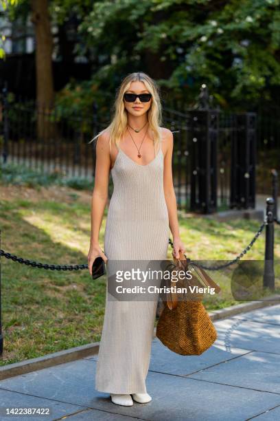Jessie Andrews wearing oversized bag, beige dress outside Proenza Schouler on September 09, 2022 in New York City.