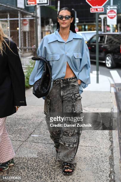 Model is seen wearing a blue shirt, charcoal jeans and black bag outside the Proenza Schouler show during New York Fashion Week S/S 2023 on September...