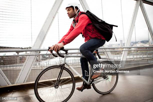 bike commuter in the city. - man wearing helmet stock pictures, royalty-free photos & images