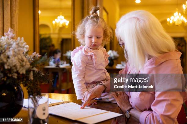 Vada with grandmother Ilona Douglas, sign a condolence book for the late Queen Elizabeth II at the Government House of Western Australia on September...