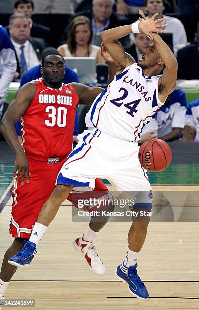 Ohio State Buckeyes forward Evan Ravenel fouls Kansas Jayhawks guard Travis Releford in the second half of the NCAA Tournament Final Four semifinals...