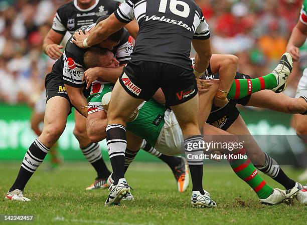 Michael Crocker of the Rabbitohs is tackled during the round five NRL match between the Wests Tigers and the South Sydney Rabbitohs at Allianz...