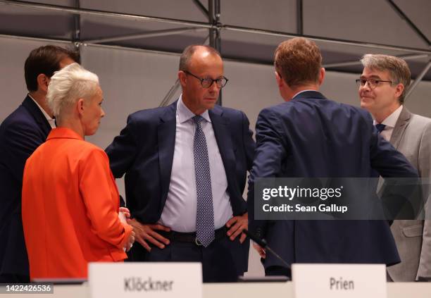 Friedrich Merz , leader of the German Christian Democrats , chats with colleagues on the second of a two-day CDU federal party congress on September...