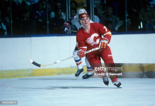 Joe Mullen of the Calgary Flames skates on the ice during an NHL game against the New York Islanders circa 1990 at the Nassau Coliseum in Uniondale,...