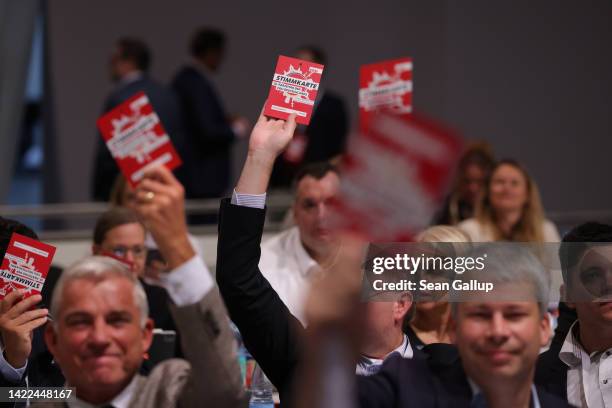 Delegates of the German Christian Democrats vote on a measure during a debate over core values on the second of a two-day CDU federal party congress...