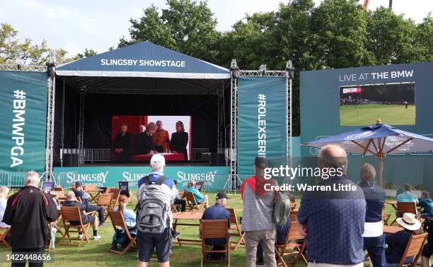 Spectators gather around LED Screens in the Fans Village to watch the proclamation of King Charles III during Round Two on Day Three of the BMW PGA...